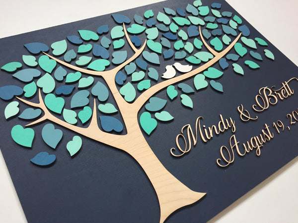 detail of wood wedding guest book with blue, turquiuse, teal, aqua leaves signyoustyle.com