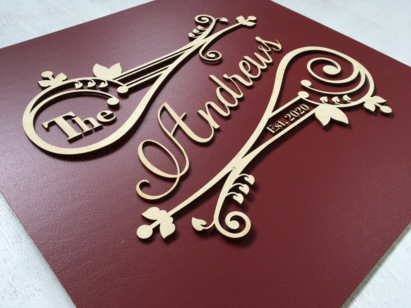 detail of wood burgundy last name sign, made on wood and customized with your name and date as well as colors