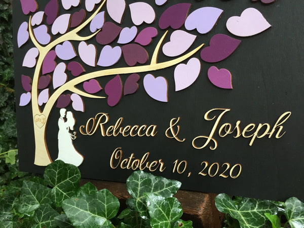 front detail of the lettering on 3D guestbook with couple and purple tree of life