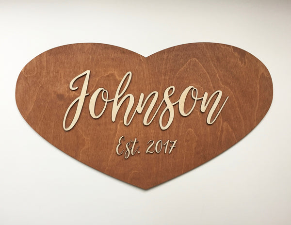 last name family sign with script lettering on rustic brown stain background 23"x13"