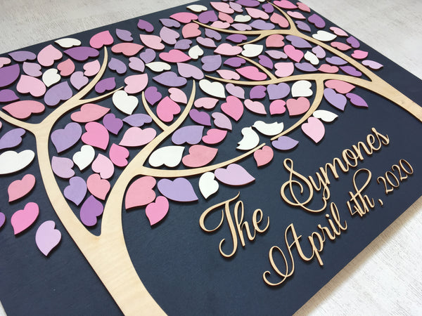 left hand side detail of last name sign with tree of life and pink purple leaves