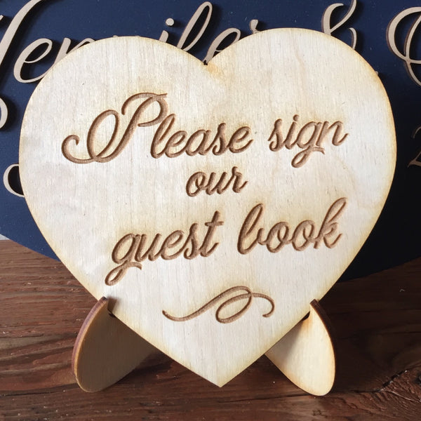 an optional engraved heart shaped sign to ask your anniversary party guests to sign your guest book