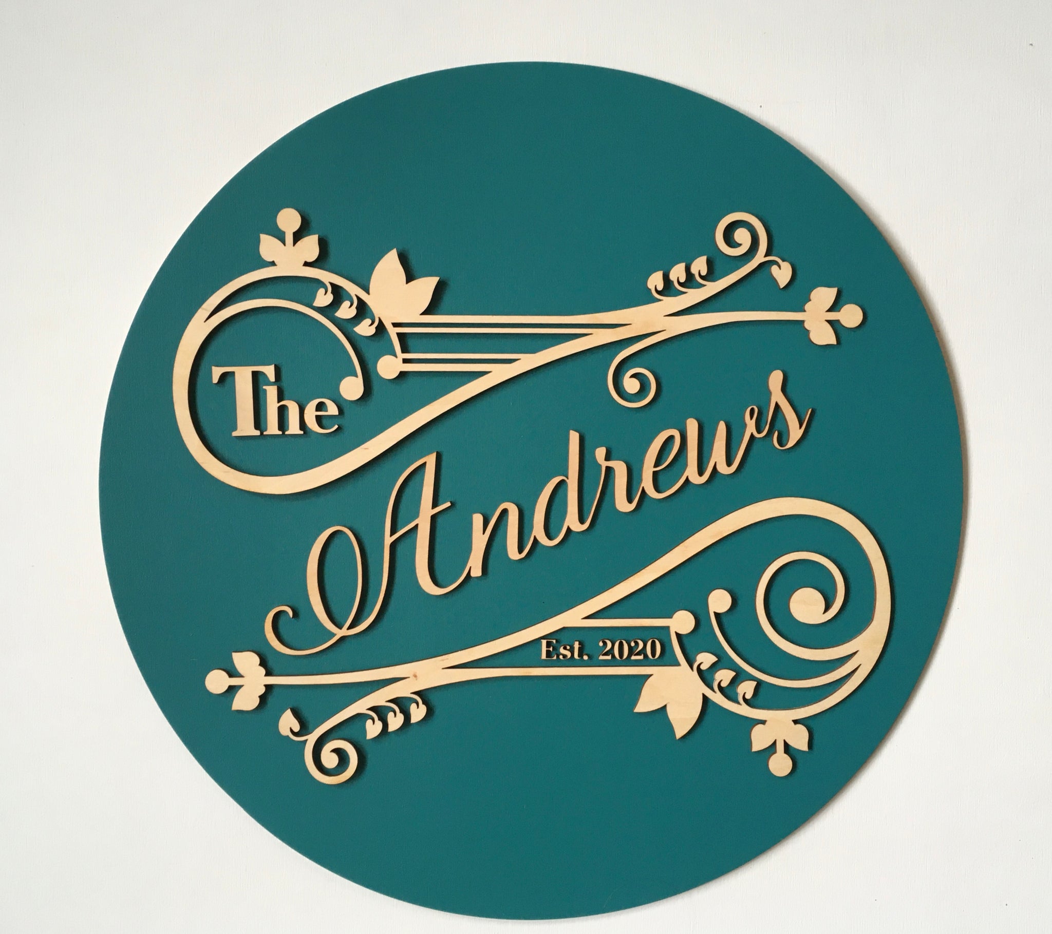 last name family sign with established date made on teal and swirled details to mimic a vintage style ad