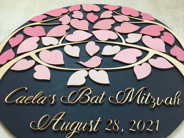 the bat mitzvah is made with a light pink bird sitting in the tree to symbolize the birthday girl