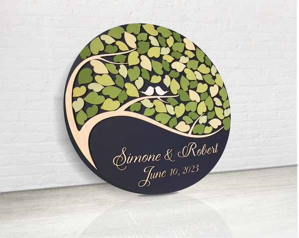 the guest book is made of 3D wood in a round shape with one tree two birds and leaves for each guest to sign their name at the wedding party by SignYouStyle