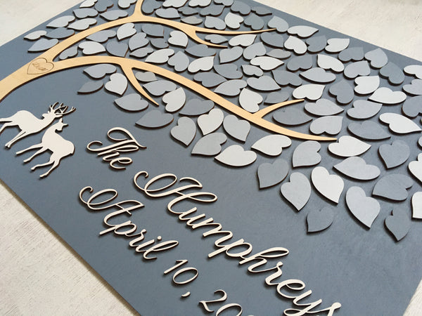 the guestbook is made with a deer couple and the last name, plus a heart with engraved initials signyoustyle.com