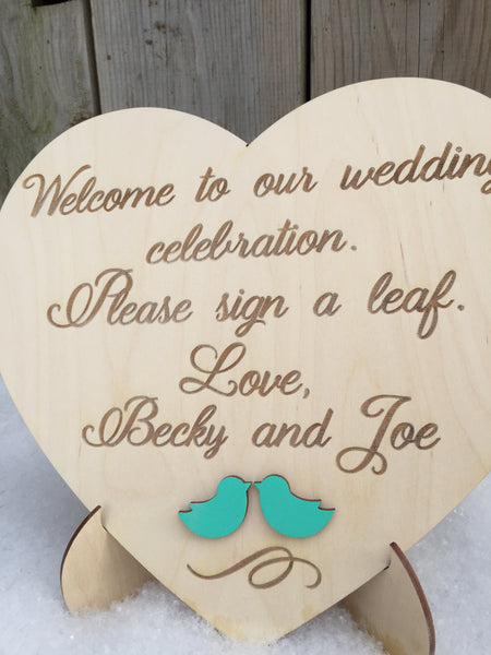 the sign also comes with two love birds in 3D with a color that can be coordinated with the color of birds you have on your guest book