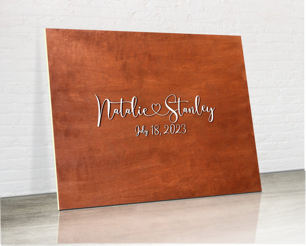 the wooden board is personalized iwth your names and wedding date and can be painted in any color